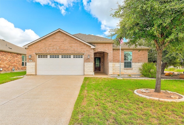 view of front of property with a garage and a front yard