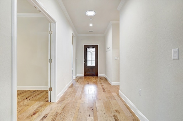 interior space featuring light wood-type flooring and crown molding