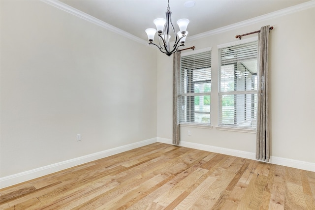 spare room with wood-type flooring, ornamental molding, and a notable chandelier