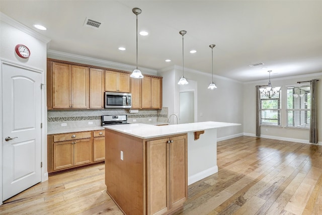 kitchen with pendant lighting, an island with sink, range with electric cooktop, light hardwood / wood-style flooring, and decorative backsplash