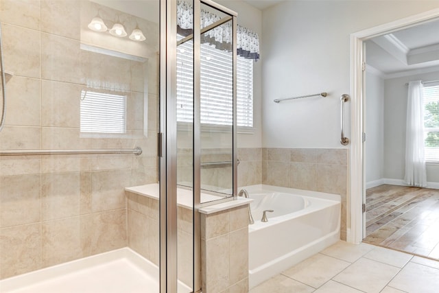 bathroom with independent shower and bath, hardwood / wood-style flooring, and ornamental molding