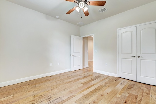 unfurnished bedroom with ceiling fan, a closet, and light hardwood / wood-style floors