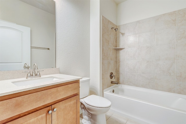 full bathroom with tile patterned floors, tiled shower / bath combo, vanity, and toilet