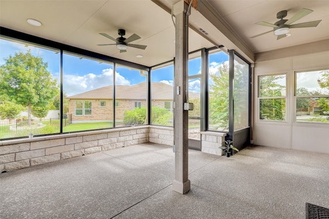 unfurnished sunroom with ceiling fan