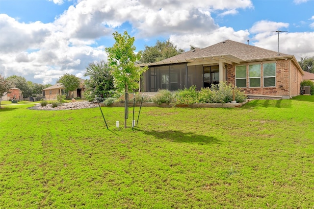 view of yard with a sunroom