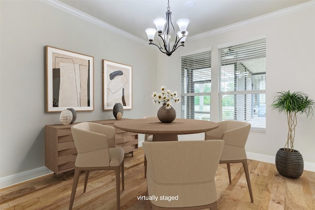 dining area with an inviting chandelier, light hardwood / wood-style flooring, and ornamental molding