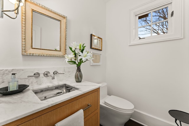 half bathroom with toilet and vanity