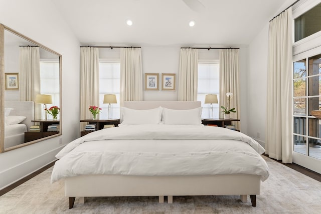 bedroom with access to outside, multiple windows, recessed lighting, and baseboards