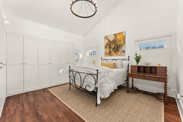 bedroom featuring a chandelier, a closet, wooden ceiling, dark wood-style floors, and high vaulted ceiling