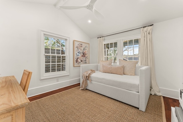 living area with a wealth of natural light, vaulted ceiling with beams, baseboards, and wood finished floors