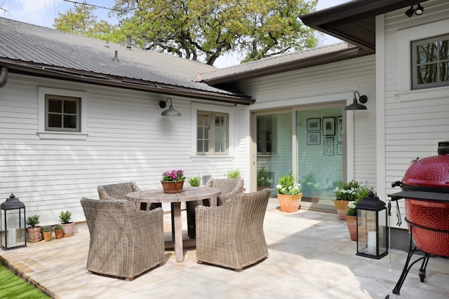 view of patio with area for grilling and outdoor dining area