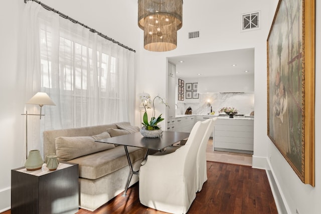 dining area featuring dark wood finished floors, visible vents, and breakfast area