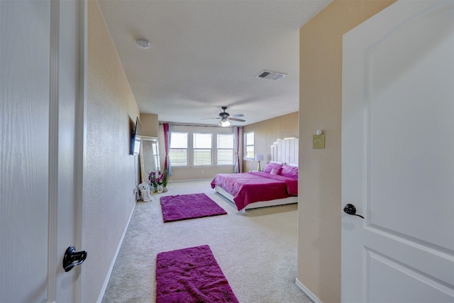 bedroom with ceiling fan and light colored carpet