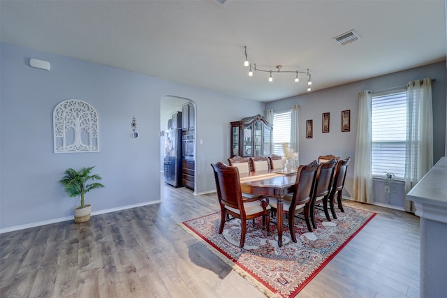 dining space with hardwood / wood-style flooring