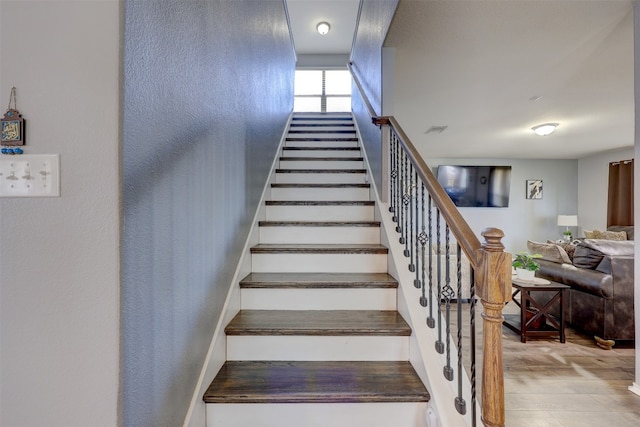 staircase with wood-type flooring