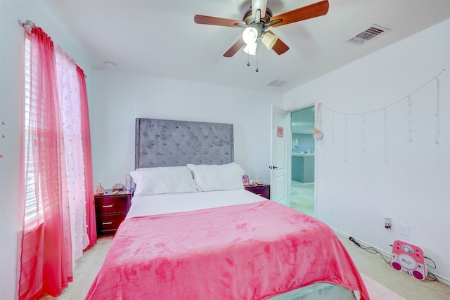 bedroom featuring light carpet and ceiling fan