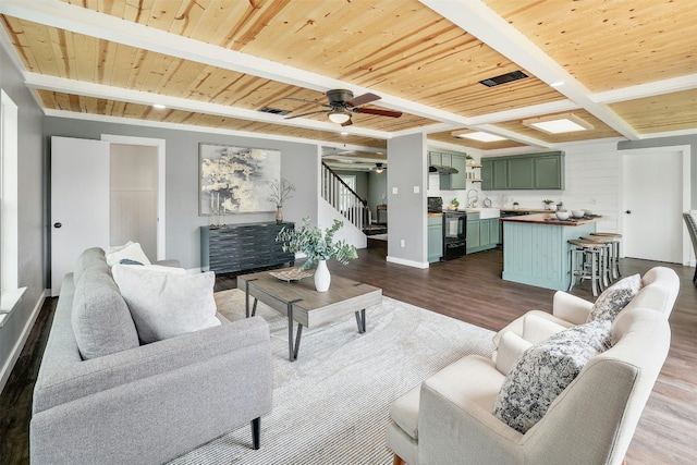 living room with beamed ceiling, ceiling fan, wood ceiling, and dark wood-type flooring