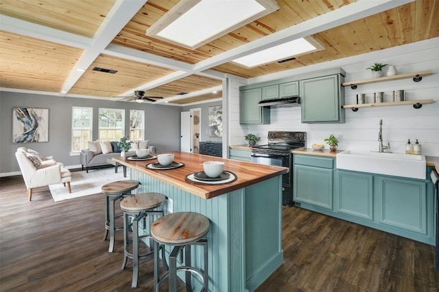 kitchen featuring black range with electric cooktop, ceiling fan, dark wood-type flooring, sink, and beam ceiling