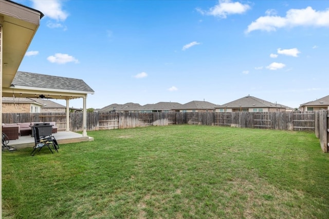 view of yard with ceiling fan and a patio