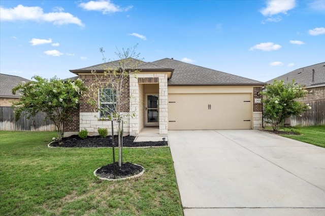 view of front of home featuring a garage and a front yard