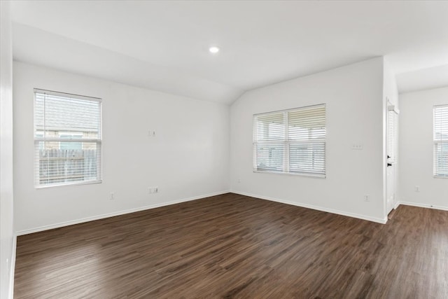 unfurnished room featuring dark hardwood / wood-style flooring and lofted ceiling