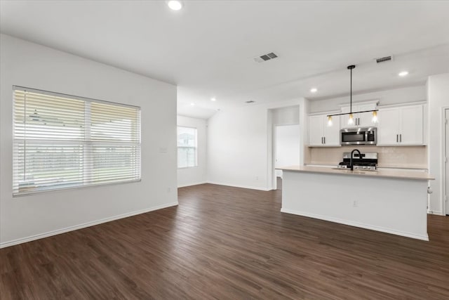 unfurnished living room with dark hardwood / wood-style flooring and sink