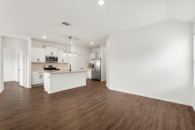 kitchen with a kitchen island with sink, appliances with stainless steel finishes, and dark wood-type flooring