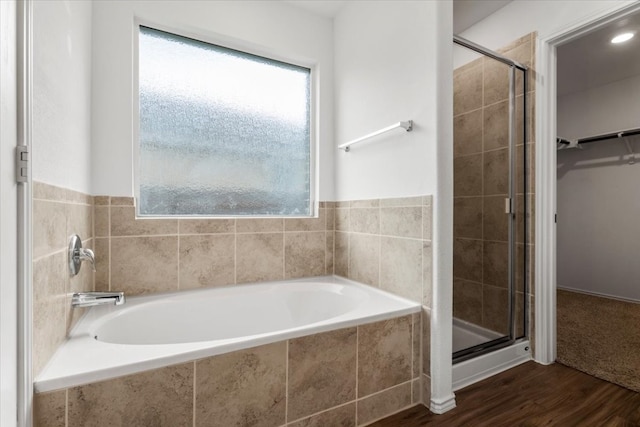 bathroom featuring independent shower and bath and hardwood / wood-style flooring