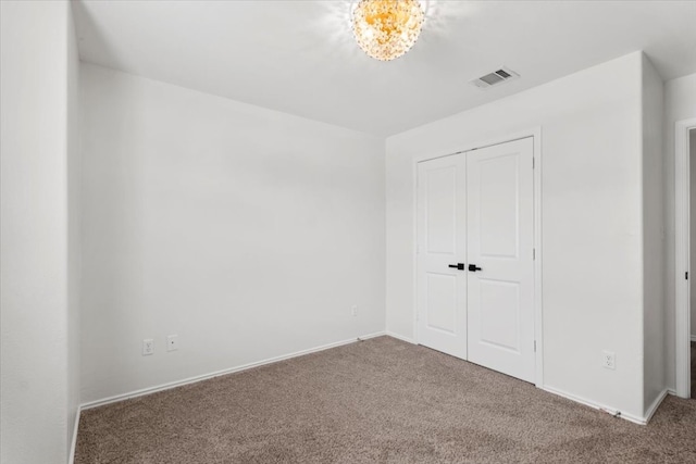 unfurnished bedroom with carpet and a closet