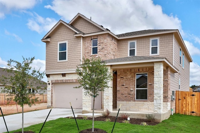 craftsman-style home featuring a front lawn and a garage