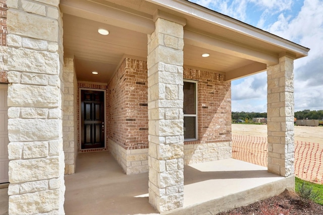 213 Skipping Stone Run, Georgetown, TX 78628 - entrance to property featuring covered porch, stone siding, and brick siding