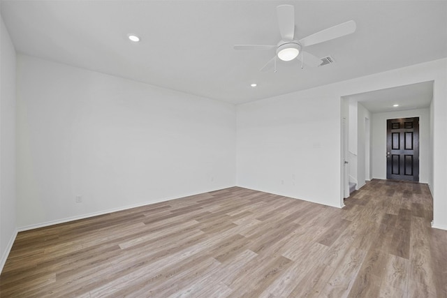 unfurnished room with light wood-type flooring and ceiling fan