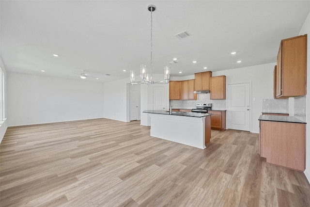 213 Skipping Stone Run, Georgetown, TX 78628 - kitchen featuring electric range oven, under cabinet range hood, dark countertops, backsplash, and recessed lighting