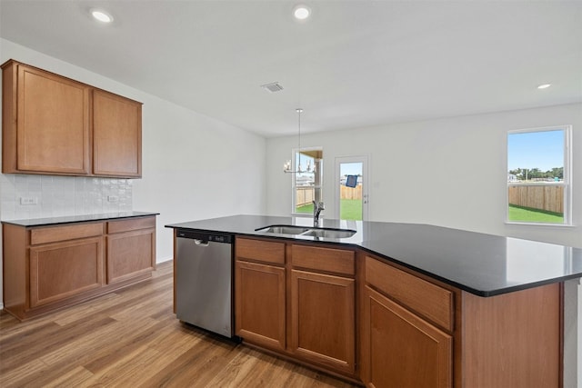 213 Skipping Stone Run, Georgetown, TX 78628 - kitchen with dishwasher, light wood-type flooring, backsplash, brown cabinets, and recessed lighting