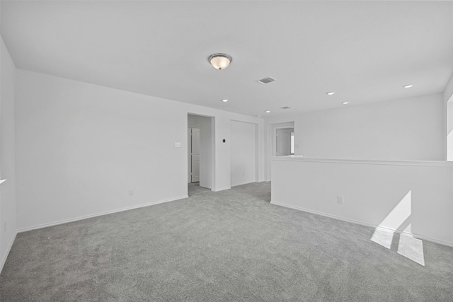 unfurnished room featuring light carpet