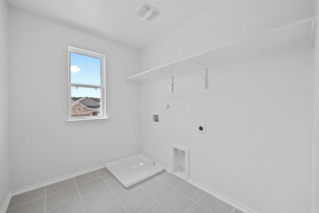 clothes washing area featuring hookup for an electric dryer, hookup for a gas dryer, light tile patterned flooring, and washer hookup