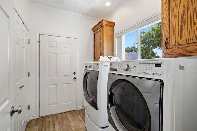 laundry area with ceiling fan, ornamental molding, cabinets, light wood-type flooring, and washer and dryer