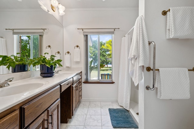 bathroom with a shower with curtain, vanity, ornamental molding, and a wealth of natural light