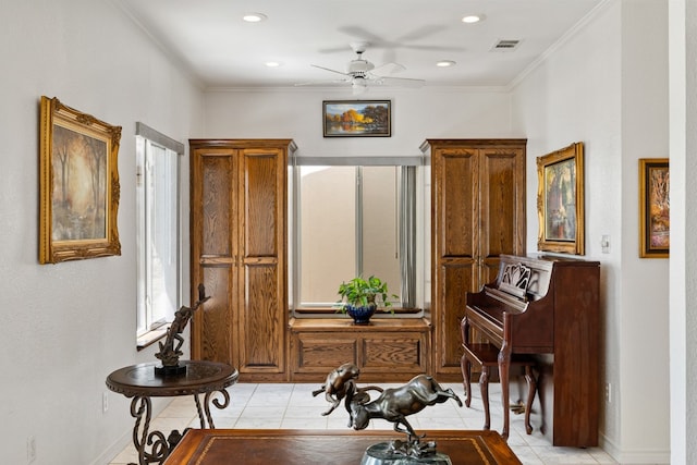 interior space with ornamental molding, ceiling fan, and light tile patterned flooring