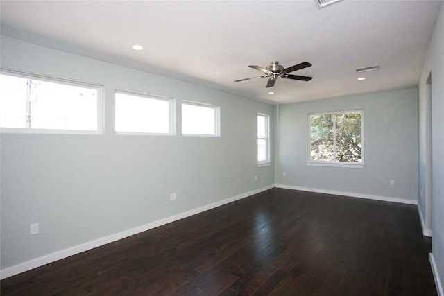 spare room featuring baseboards, visible vents, recessed lighting, ceiling fan, and dark wood-type flooring