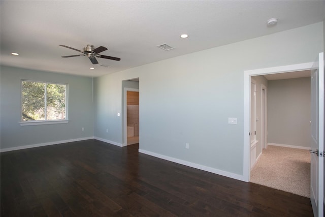 spare room with ceiling fan and dark hardwood / wood-style flooring