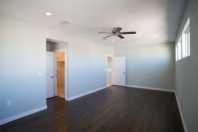 unfurnished room featuring dark wood-type flooring and ceiling fan