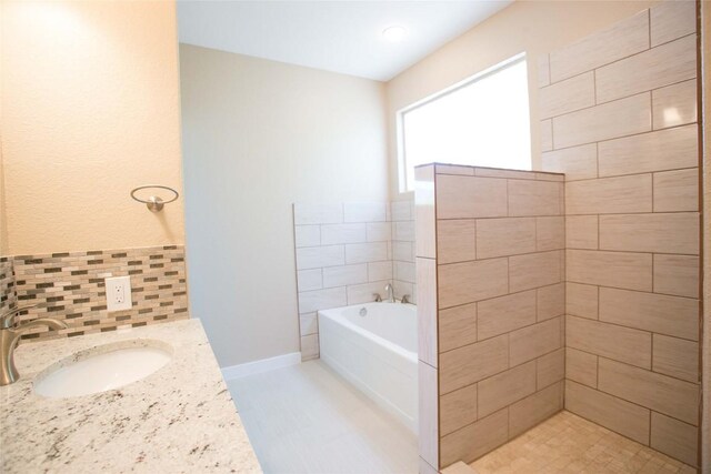 bathroom featuring plus walk in shower, backsplash, and vanity