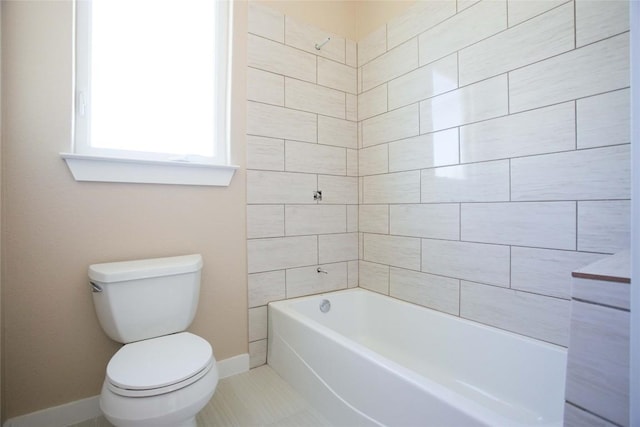 bathroom with bathtub / shower combination, tile patterned floors, toilet, and baseboards