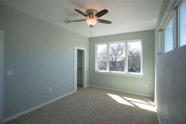 spare room featuring visible vents, baseboards, carpet, and ceiling fan