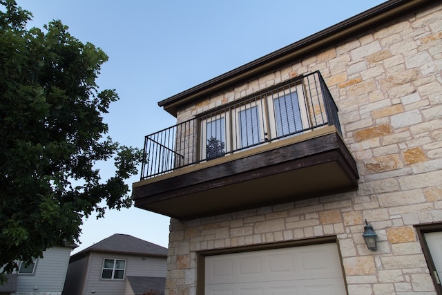 view of home's exterior featuring a balcony and a garage