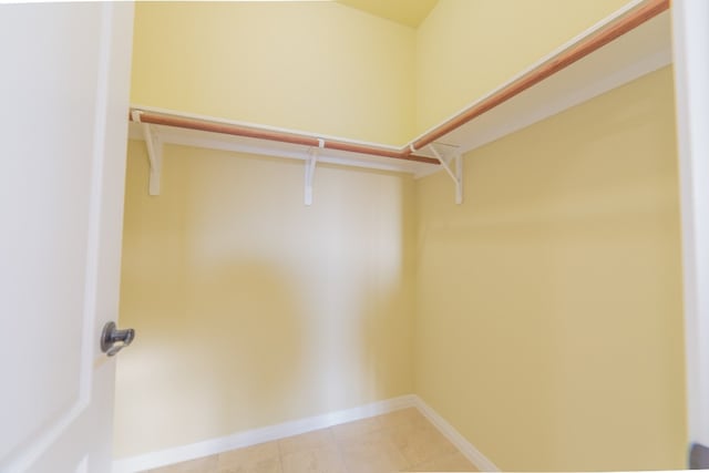 spacious closet with light tile patterned floors