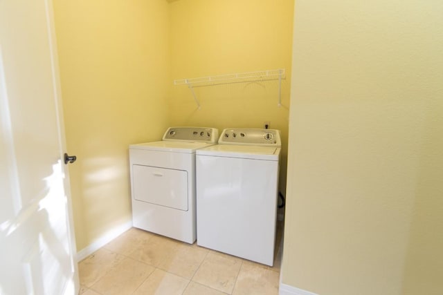 2101 Town Centre Dr Unit 1408, Round Rock, TX 78664 - washroom with washing machine and clothes dryer, light tile patterned floors, and baseboards