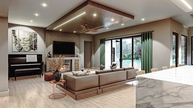 living room featuring light wood-type flooring and a large fireplace