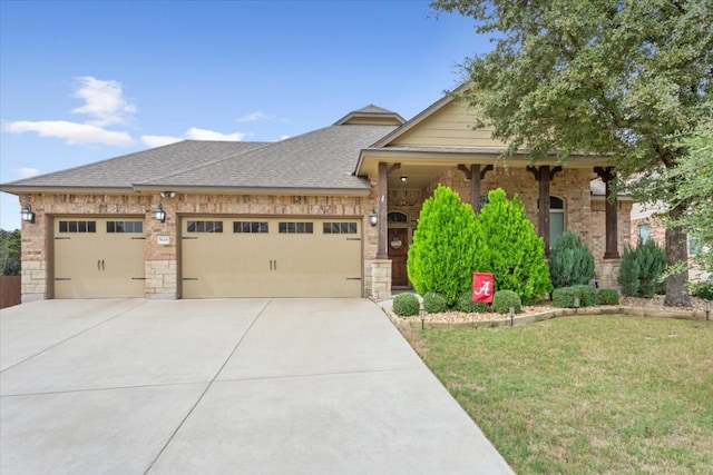 view of front of house featuring a front yard and a garage